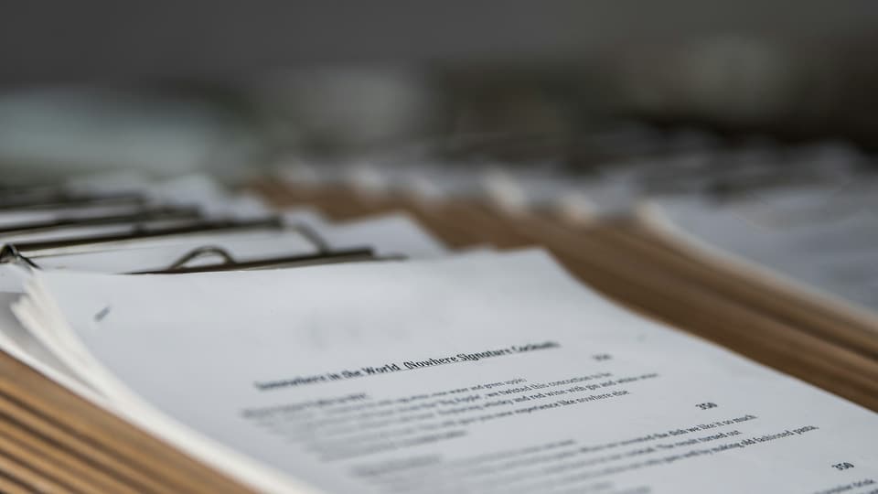 Printed documents clipped in a row of clipboards